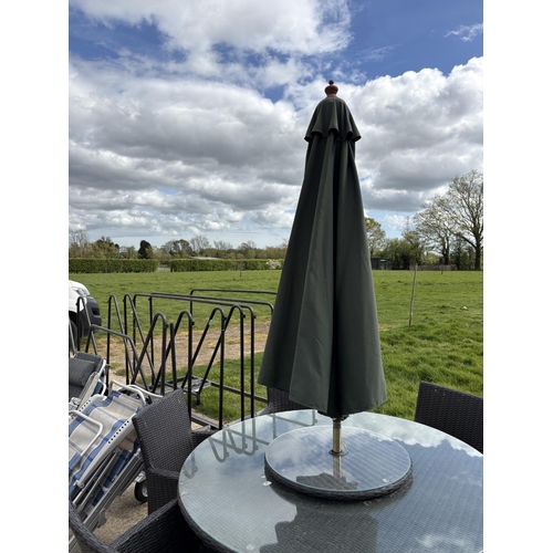 481 - A  modern black ratan garden table together with six chairs,  lazy Susan and parasol 142cm diameter