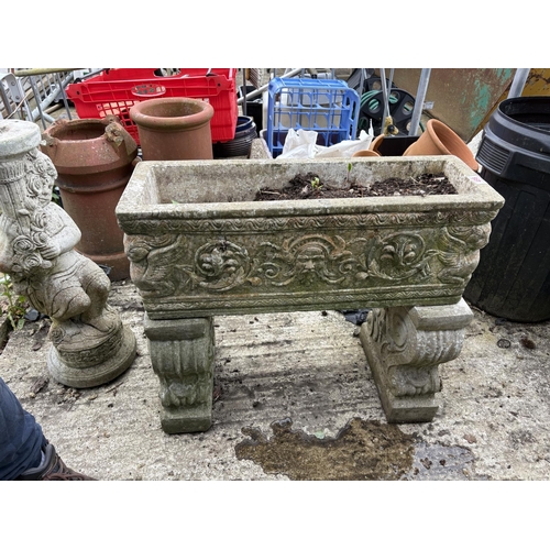 498 - A large ornate concrete trough raised on supports,  length 72 cms, width 24 cms, height 64 cms