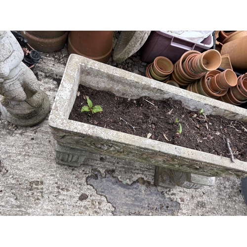 498 - A large ornate concrete trough raised on supports,  length 72 cms, width 24 cms, height 64 cms