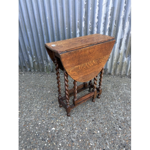 74 - A good quality slim oak barley twist gate leg table 60x23