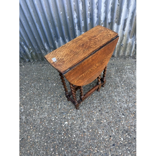 74 - A good quality slim oak barley twist gate leg table 60x23