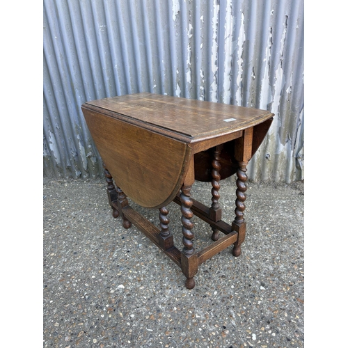74 - A good quality slim oak barley twist gate leg table 60x23