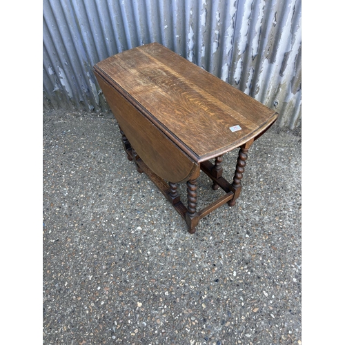 74 - A good quality slim oak barley twist gate leg table 60x23