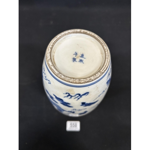558 - Oriental blue and white dragon vase, height 28cms