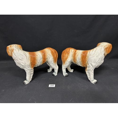 644 - Pair of vintage St Bernard Dog Figures, each length 33 cms, (one minus one eye)