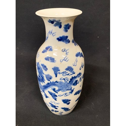 558 - Oriental blue and white dragon vase, height 28cms