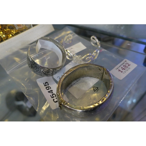 1482 - 2 SILVER BANGLES AT 55G AND 1 SILVER COLOURED BANGLE