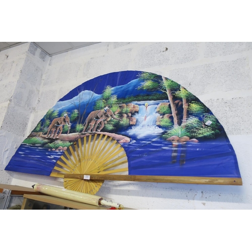 1327 - A VERY LARGE DECORATIVE FAN PAINTED WITH A RIVERSIDE SCENE AND ELEPHANTS