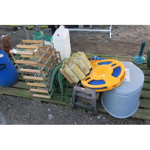 39 - WINE RACK, 2 GARDEN HOSES, CAR RAMPS, PORTABLE TOILET AND WOODEN LAWN EDGING