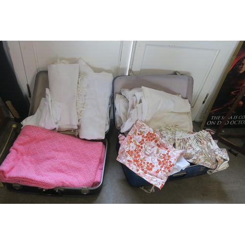 1396 - TWO SUITCASES OF LINENS AND BEDSPREADS