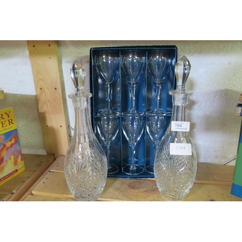 704 - 2 CUT GLASS DECANTERS AND 6 WINE GLASSES BOXED