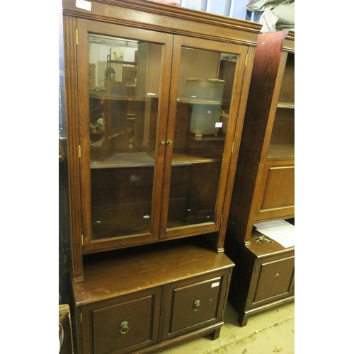 1624 - A DARK WOOD BOOK CASE WITH GLASS FRONT AND CUPBOARD BENEATH