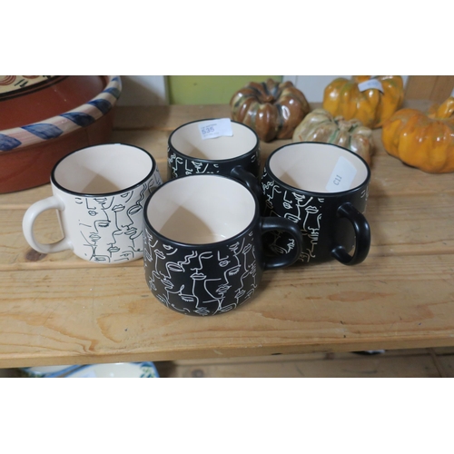 535 - A SET OF FOUR FACE PRINT MUGS