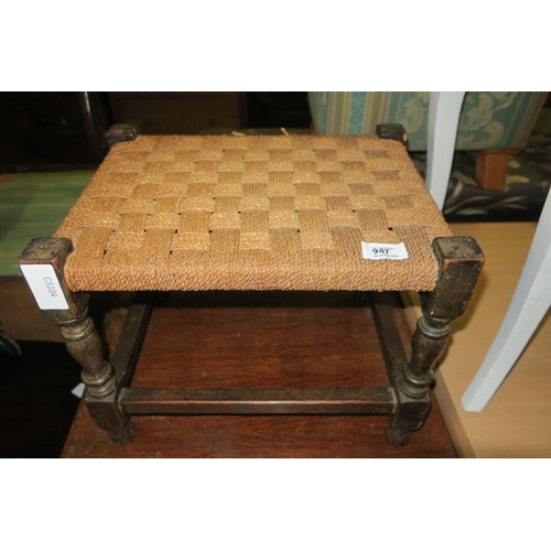 947 - A SMALL WOVEN TOP FOOT STOOL