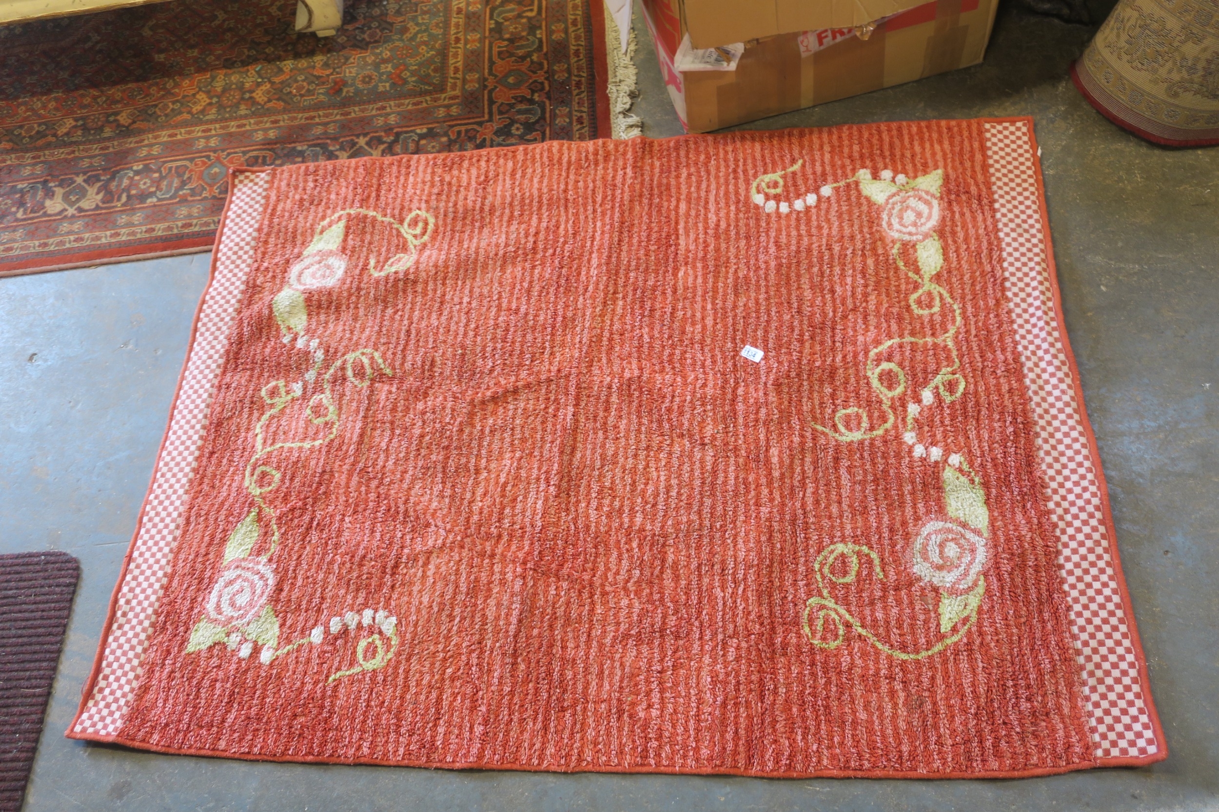 RED AND PINK STRIPED RUG WITH SWIRLY GREEN EDGING