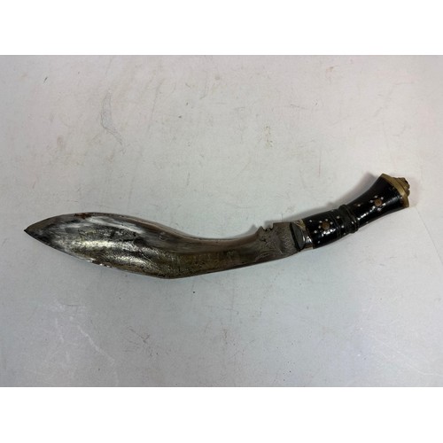 138 - A 20thC Indian Kukri, a principal knife, with a lion's head terminal, two smaller knives, in a toole... 