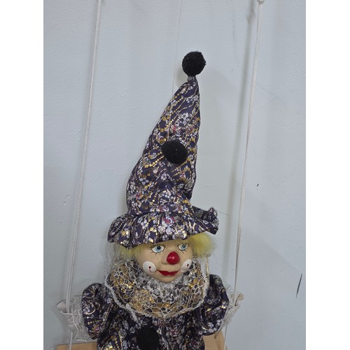 38 - Vintage puppet style young clown with porcelain face and stuffed body on a string. Length of doll is... 