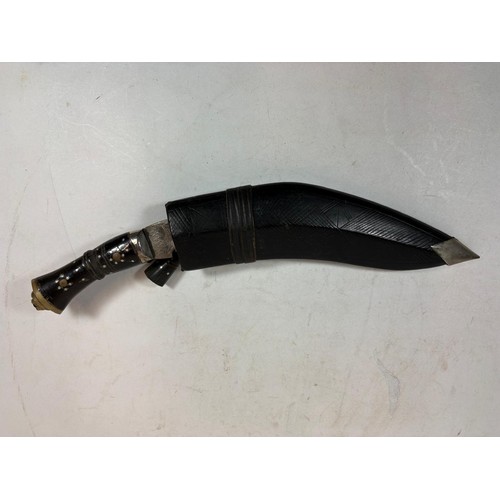 41 - A 20thC Indian Kukri, a principal knife, with a lion's head terminal, two smaller knives, in a toole... 