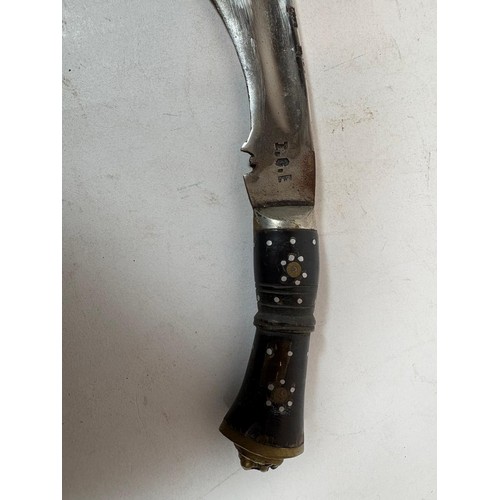 41 - A 20thC Indian Kukri, a principal knife, with a lion's head terminal, two smaller knives, in a toole... 
