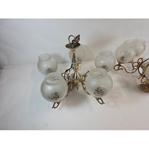 53 - A pair of antique or vintage Brass Chandeliers with frosted glass globe shades.