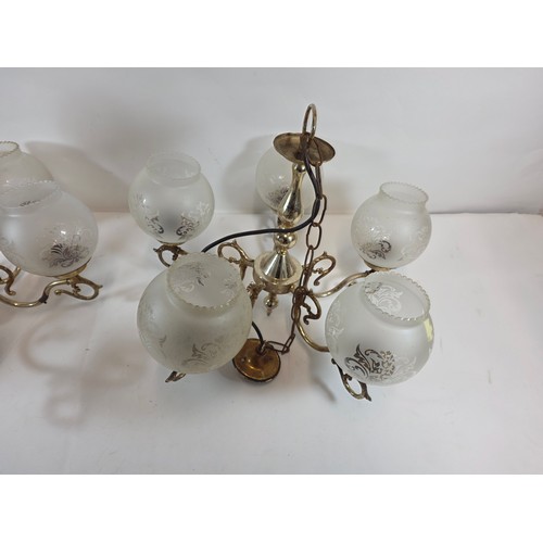 53 - A pair of antique or vintage Brass Chandeliers with frosted glass globe shades.