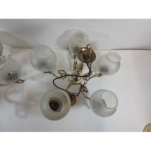 53 - A pair of antique or vintage Brass Chandeliers with frosted glass globe shades.