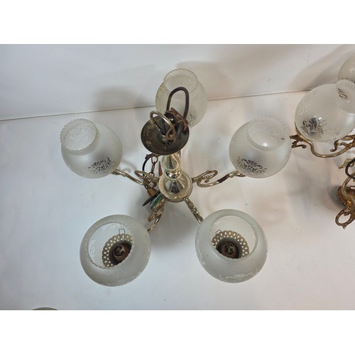 53 - A pair of antique or vintage Brass Chandeliers with frosted glass globe shades.
