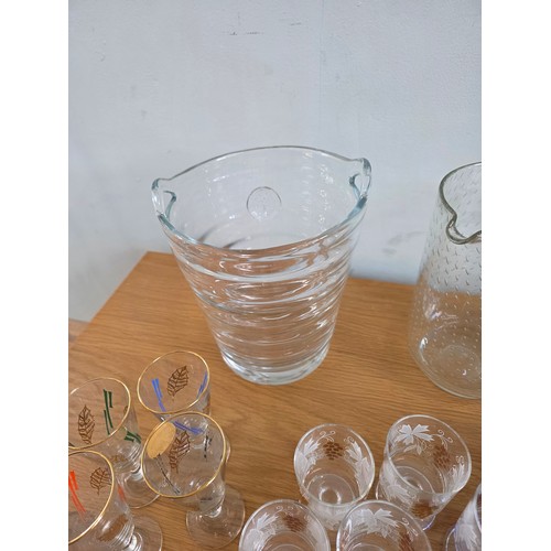 30 - A mixed lot of vintage glass to include Ice bucket, juice jug, candle sticks, paperweights, a bonbon... 