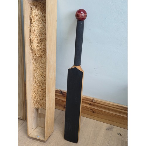 47 - A novelty chalk board in the form of traditional cricket bat with cricket ball surmount. Presented i... 