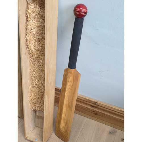 47 - A novelty chalk board in the form of traditional cricket bat with cricket ball surmount. Presented i... 