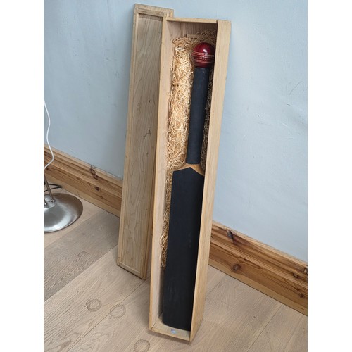 47 - A novelty chalk board in the form of traditional cricket bat with cricket ball surmount. Presented i... 