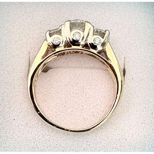 49 - A 14ct diamond set dress ring.Centrally set with a round brilliant cut diamond flanked by two furthe... 