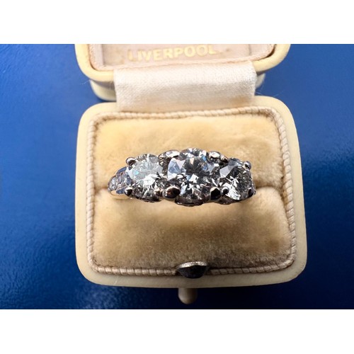 49 - A 14ct diamond set dress ring.Centrally set with a round brilliant cut diamond flanked by two furthe... 