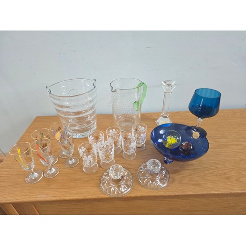 A mixed lot of vintage glass to include Ice bucket, juice jug, candle sticks, paperweights, a bonbon jar and sets of five and six glasses