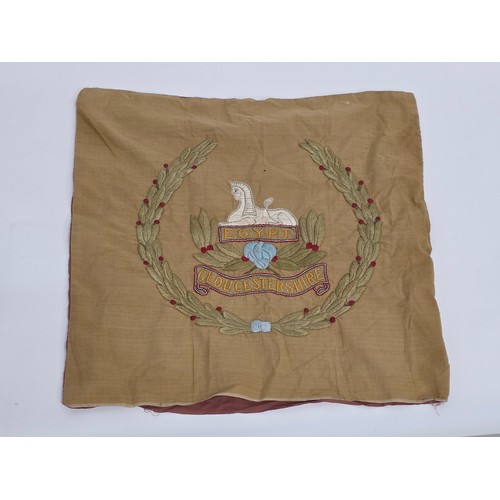Of Gloucestershire Regiment interest. A hand embroidered cushion cover depicting the regimental badge. 