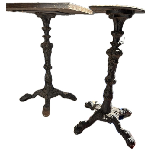 82 - A pair of 19th century style cast iron single pedestal pub side tables, raised on four lion paw feet... 