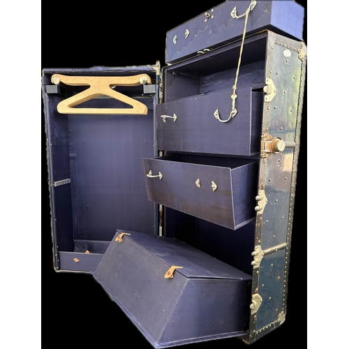 83 - A fine quality fitted travelling trunk, silk lined with 3 drawers, a hinged shoe box and wardrobe.&n... 