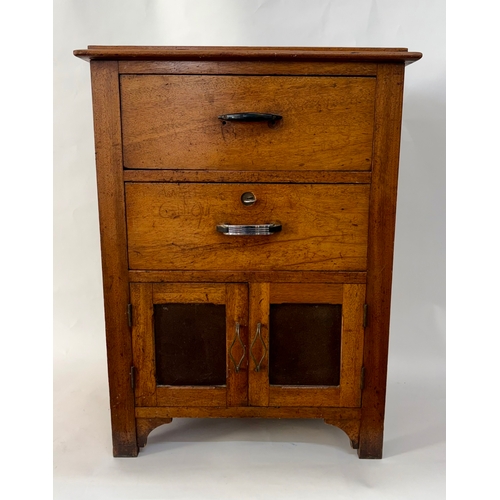 84 - An antique arts and crafts style solid walnut cabinet chestThe top with moulded edge, above two shor... 