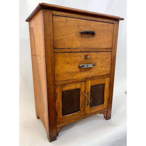 84 - An antique arts and crafts style solid walnut cabinet chestThe top with moulded edge, above two shor... 