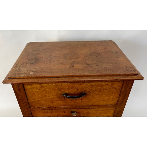 84 - An antique arts and crafts style solid walnut cabinet chestThe top with moulded edge, above two shor... 