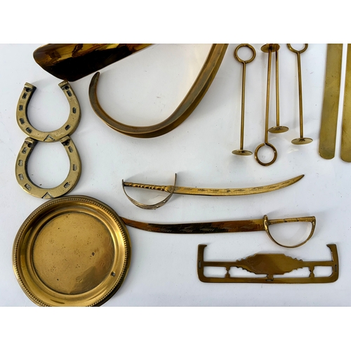 85 - A selection of early 20th century brass ornaments and collectibles to include button polisher slides... 