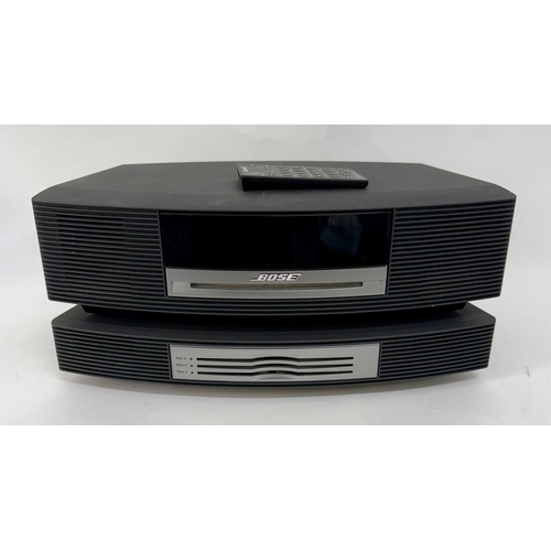 89 - A Bose Wave Music System, with a Wave Music System Multi-CD Changer.Together with cabling, manuals a... 
