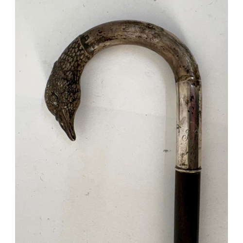 98 - A white metal late 19th century ebony colored walking cane with pheasant head handle.Engraved H.V.D.... 