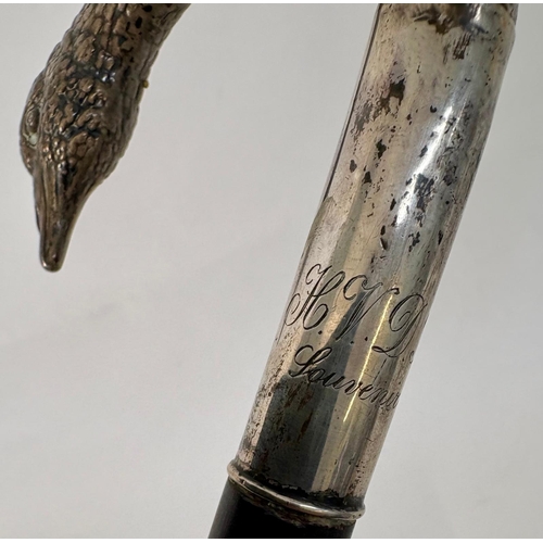 98 - A white metal late 19th century ebony colored walking cane with pheasant head handle.Engraved H.V.D.... 