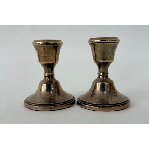 112 - A pair of Georgian style weighted squat silver candlesticksR&D Birmingham 1971(2)