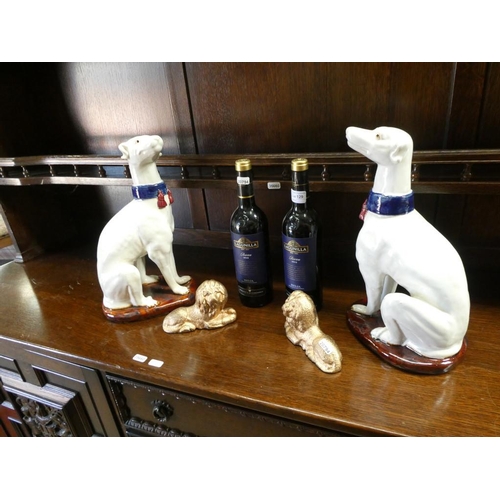 129 - Pair of ornamental dogs pair of ornamental lions & 2 bottles of Lagunilla