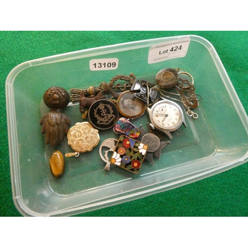 424 - Tub containing silver neck chain, pendants, cap badges, miniature compass etc