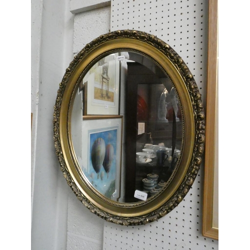 528 - Oval gilt framed bevel edged mirror