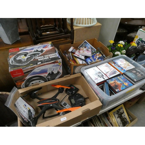 643 - 2 Boxes of DVD's, racing wheel, Falcon HD upgrade drone with remote (sold as seen)