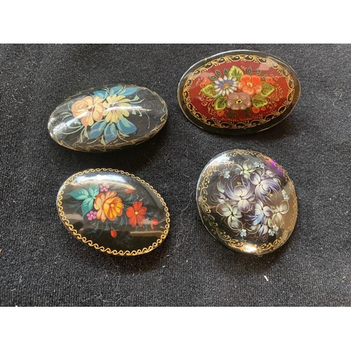 103 - 4 Russian hand painted brooches - 1 signed